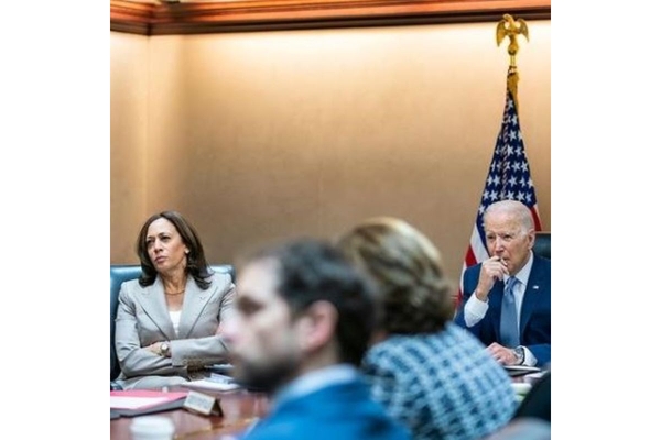 Image Joe Biden and Kamala Harris at a table with other policy makers.