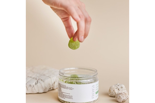 Image Person taking gummy out of a jar.