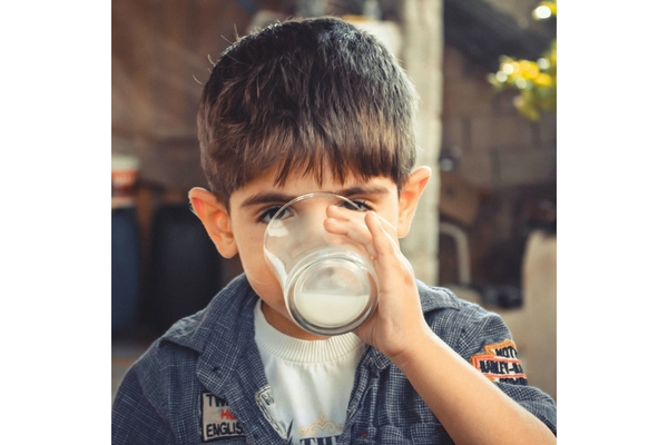 Image child drinking milk from a glass