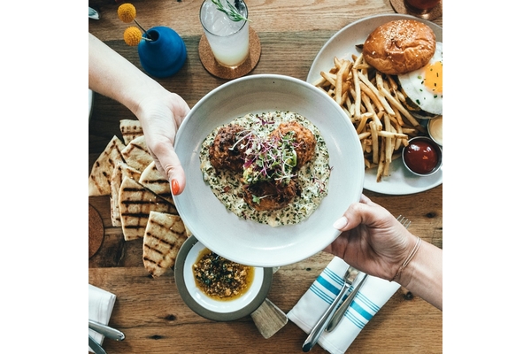 Plate of food being handed over to someone else