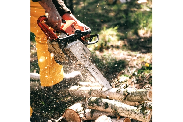 Image man using a saw hammer to slice a piece of wood