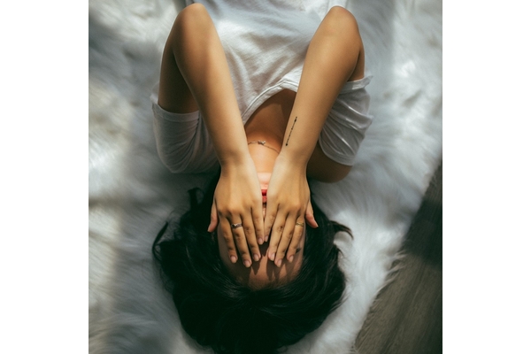 Image Woman struggleing with mental issues feeling sad and laying in bed