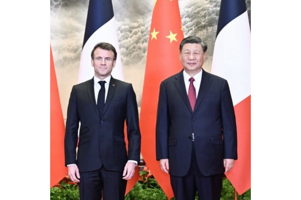 President’s Macron and Xi Jinping standing in front of the nations' flags.
