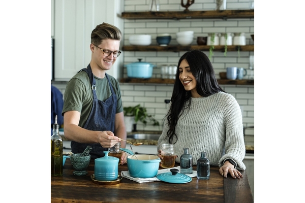 Young couple cooking with different ingredients