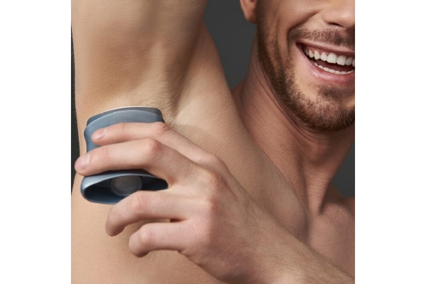 Image A man applies deodorant.