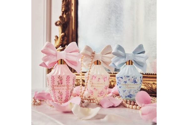 A bottle of the perfume Forever in Love by the brand LoveShackFancy.