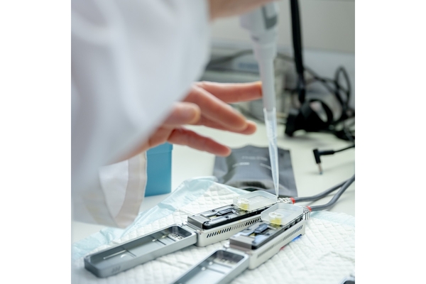 Scientist's hand working in the lab.