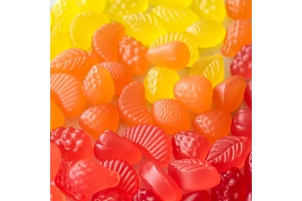 Gummy candies are in different colors, including yellow, orange, and red.