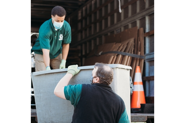 Image waste collectors loading a grey bin into the lorry