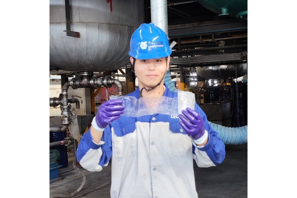 Worker holding newly produced plastics in hands.