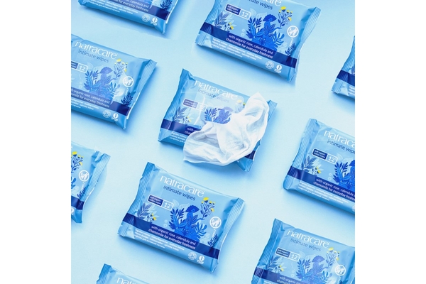 Packs of wet wipes organized in diagonals with one packet open.