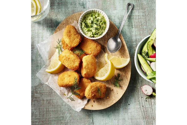 A plate of plant-based nuggets are placed on a table.