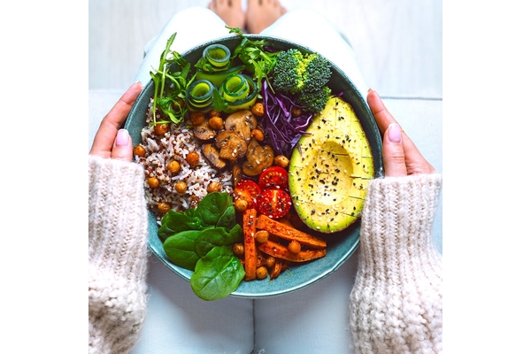 Image A bowl of food is held by a person.