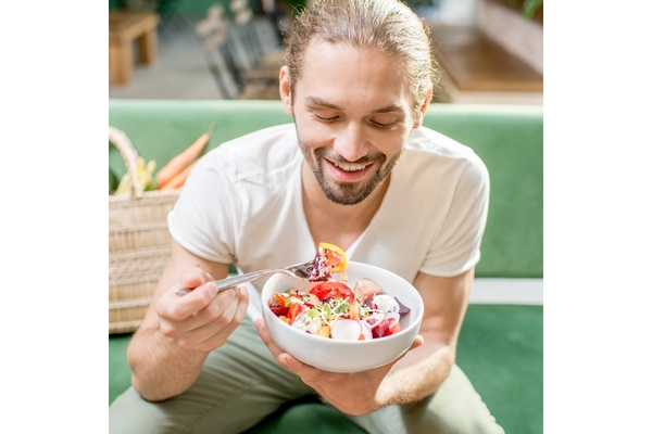 Image Man eating plant-based lunch.