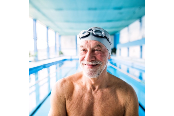 Image Senior man in an indoor swimming pool.
