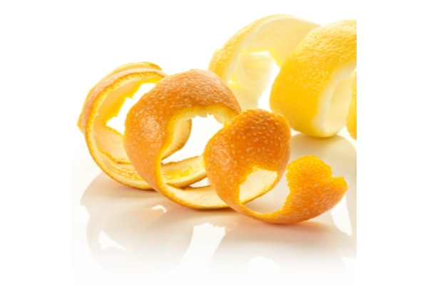 Two pieces of orange skins are placed on a white table.
