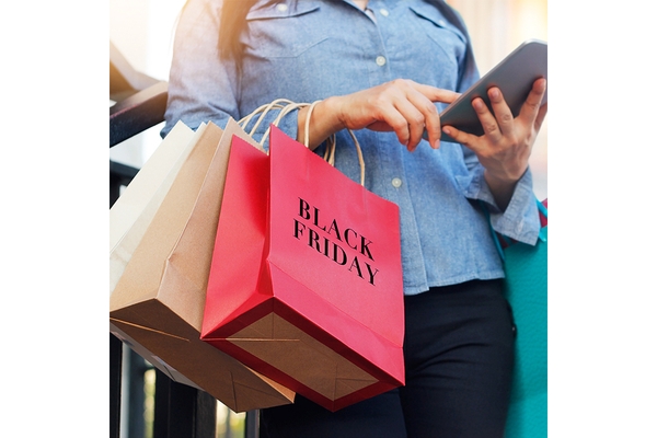 Image Shopper with mobile device at Black Friday sales.