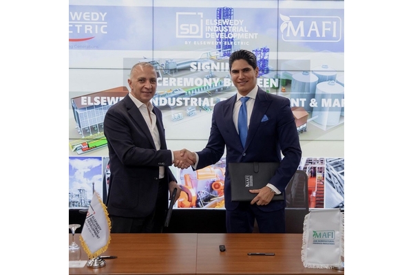 Image Two men in suits shaking hands after a business deal.
