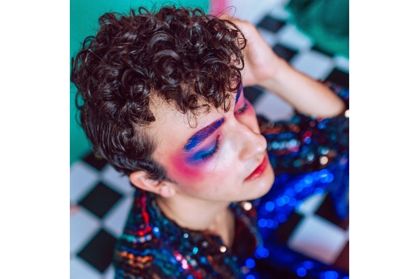 Man wearing colorful makeup