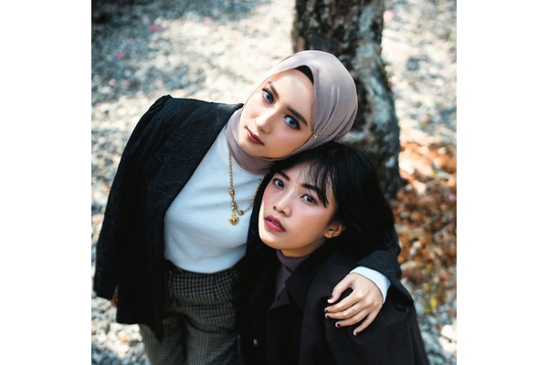 Photo Of hijabi woman Hugging asian woman.