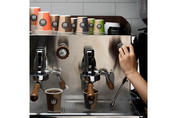 Image Person making coffee-to-go in cafe.