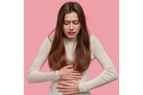 Woman hold her stomach in plain.