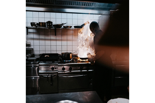 Image Chef cooking in kitchen.