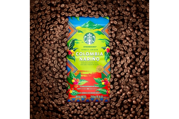 Image Starbucks Colombian coffee new pack surrounded by brown coffee beans.