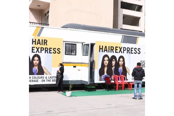 Image A caravan with Schwarzkopf branding all over it.
