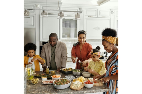 Image Family cooking mycoprotein Quorn foods in their kitchen.
