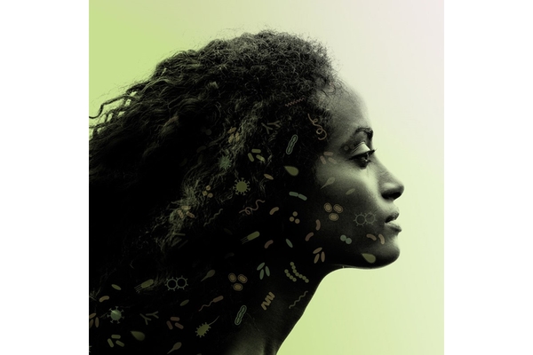 The profile of someone in front of a green background.