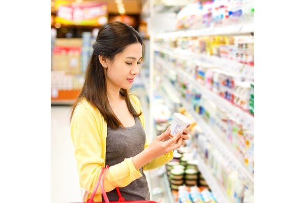 Asian woman shopping in supermarket.