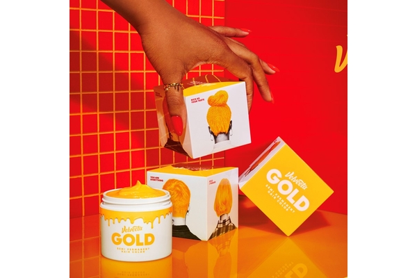 A hand grabbing Velveeta cheese hair dye.