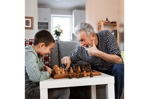 Image A man beating a child at a game of chess.