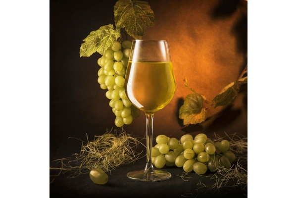 Image Chardonnay wine, vines in the background.