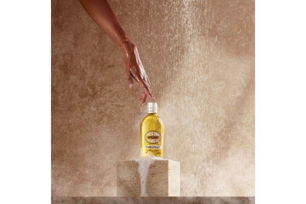 arm reaching out to L’Occitane's bath product
