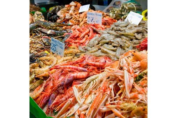 Image Different types of fresh seafood displayed in a street market.