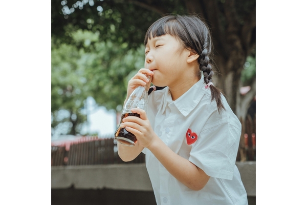 A Chinese child drinking cold drink.
