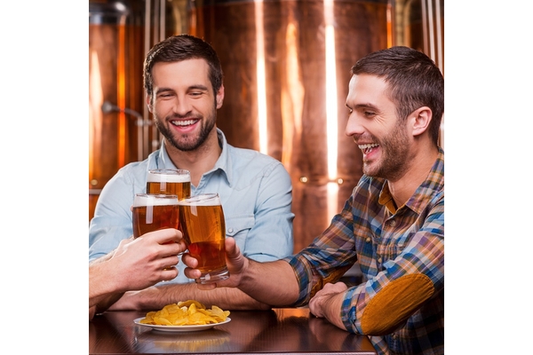 Image Two men holding glasses of beer.