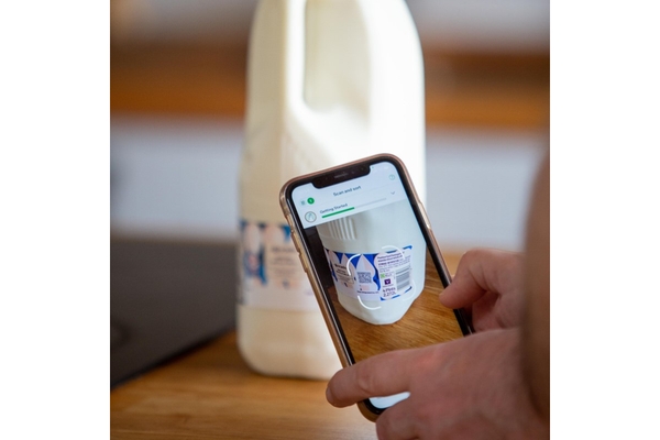 Scanning QR code on milk bottle.