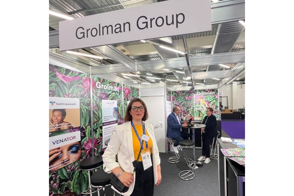 Image Woman stands in front of Grolman booth at show