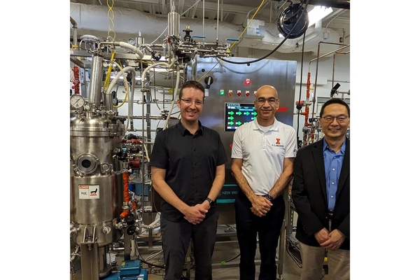 Three men in a food factory.