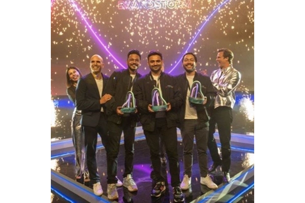 winners on stage holding award