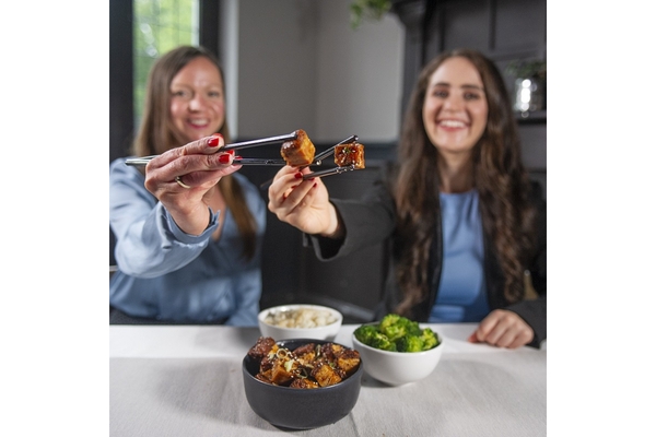 two girls holding cultivated meat.