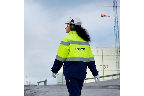 Image Neste employee walking over compound.