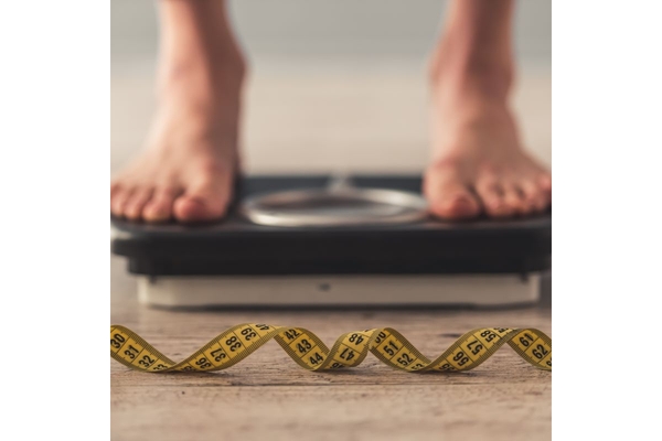 Image Person standing on a weight scale.