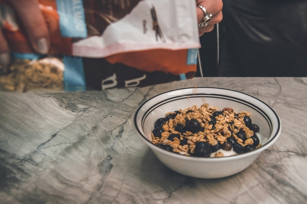 Image A bag pouring out cereal with blueberries and yogurt