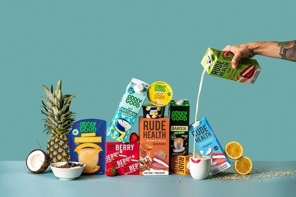 Image various plant-based drinks against a green background.