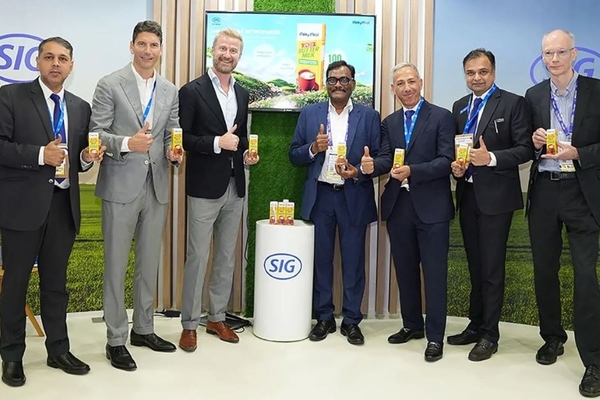 A group of men holding up their product.