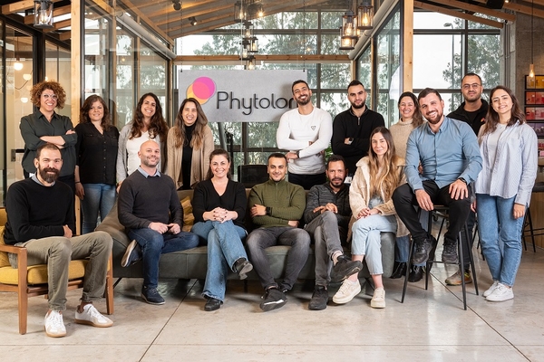 a group of people in the office posing for a group photo.